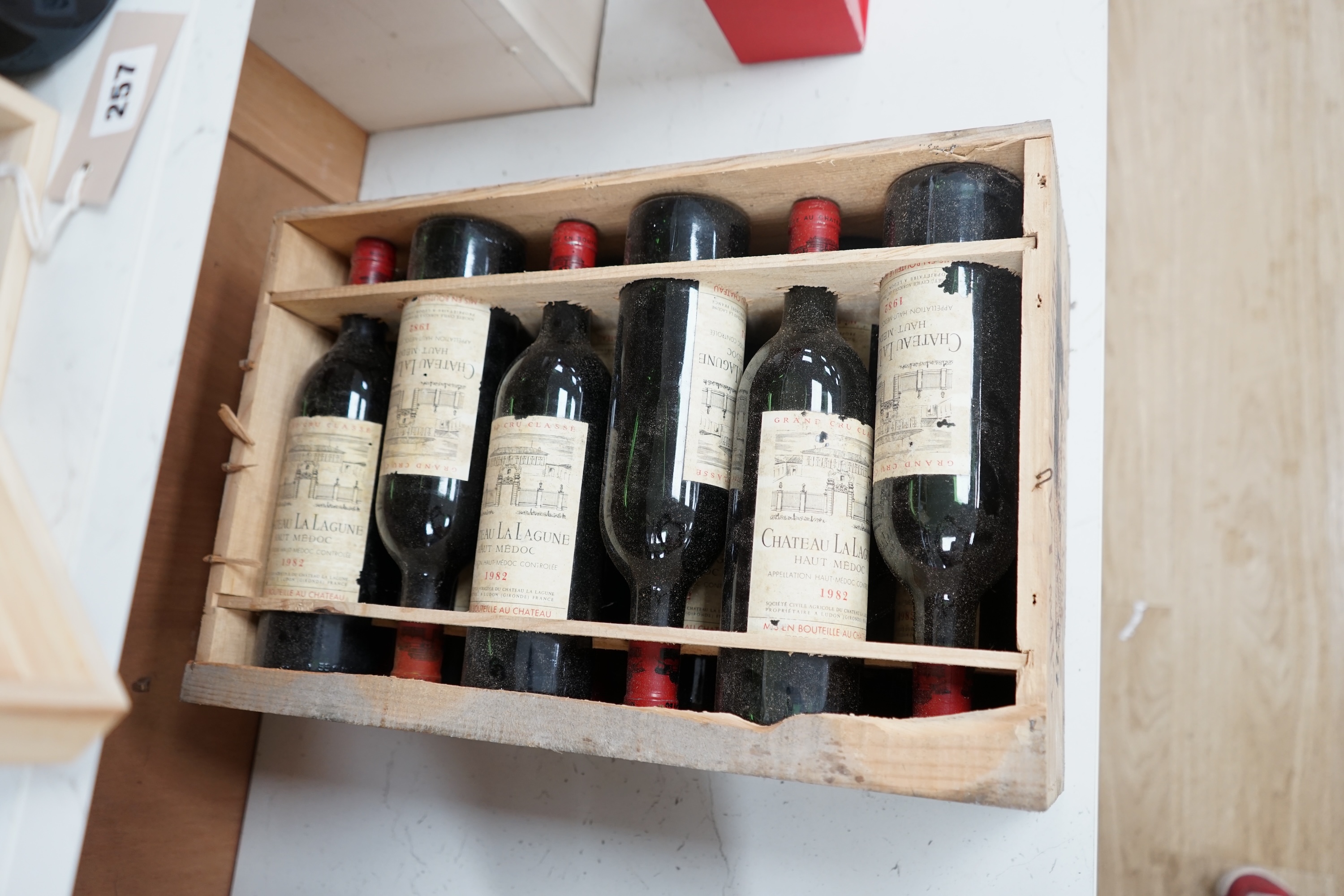 A case of twelve Chateau La Lagune, Haut-Medoc, 1982, France, OWC. Condition - fair, lacking cover. Storage history unknown